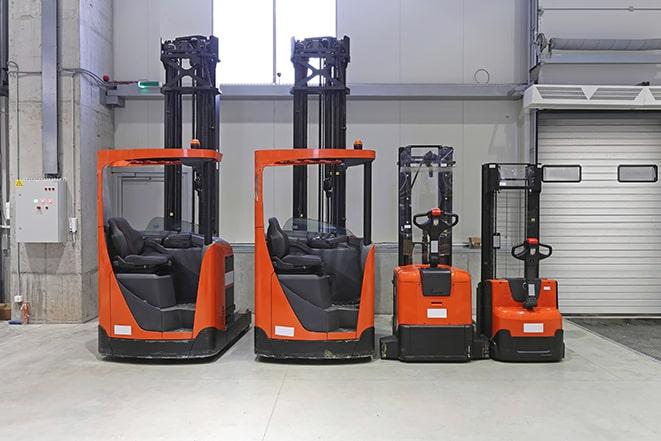 forklifts stacking pallets of bricks at a building materials store